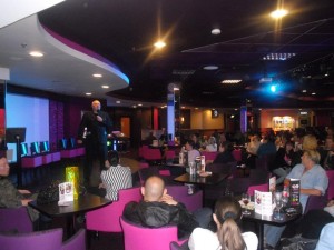 comedy stage hypnotist Adam Night on stage